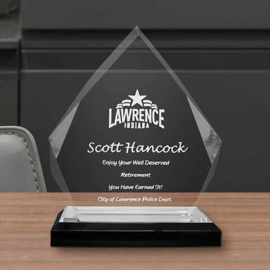 Fully customizable diamond acrylic award on a silver mirrored base, sitting on a desk to display an achievement or award.