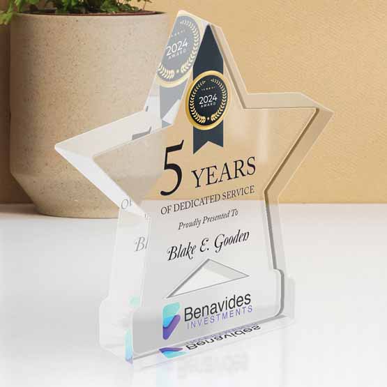 Custom Star Shaped Standing Acrylic Award for 5 Years of Service on a Desk near plant