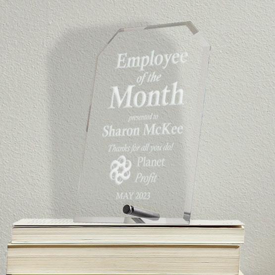 Custom Engraved Clipped Corners Glass Economy Award with your Text and Logo on Stack of Books.