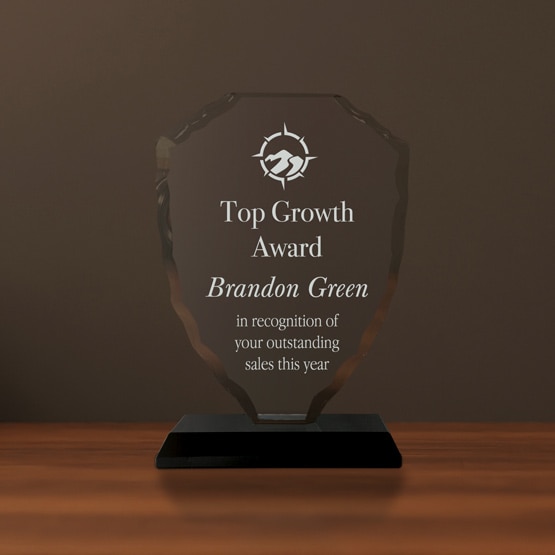 Custom Glass Award - Faceted Shield Award on a desk on a black base for easy freestanding display.