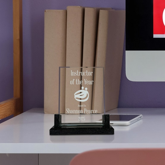 Custom Glass Award - Rectangle Glass Award with a Marble base sitting on desk with custom award laser engraved on glass.