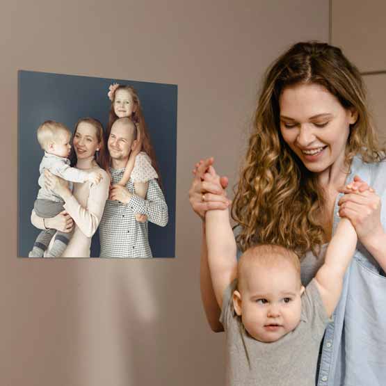 Large Custom Metal Print of Happy Family on Aluminum. This print is attached to a wall near mom and baby.