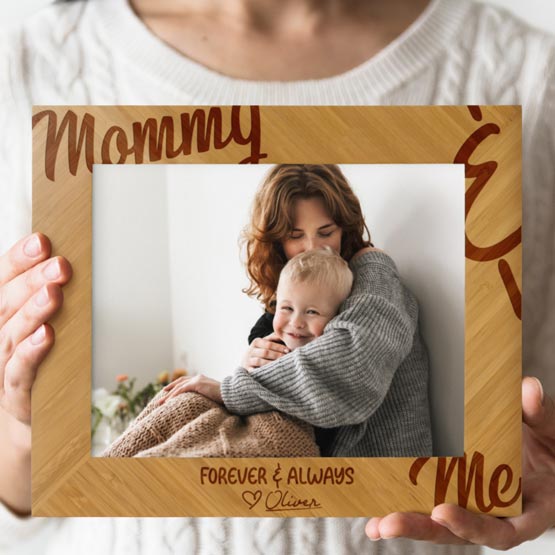 Custom Engraved Bamboo Picture Frame from Oliver to his Mom being held by woman.