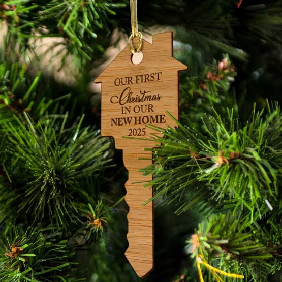 Customizable Key Ornament crafted from eco-friendly bamboo hanging in a Christmas tree by a golden string that is included.