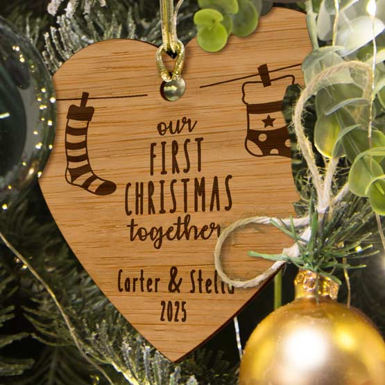 Customizable Hanging Stocking Ornament crafted from eco-friendly bamboo hanging by a golden string in a Christmas tree. 