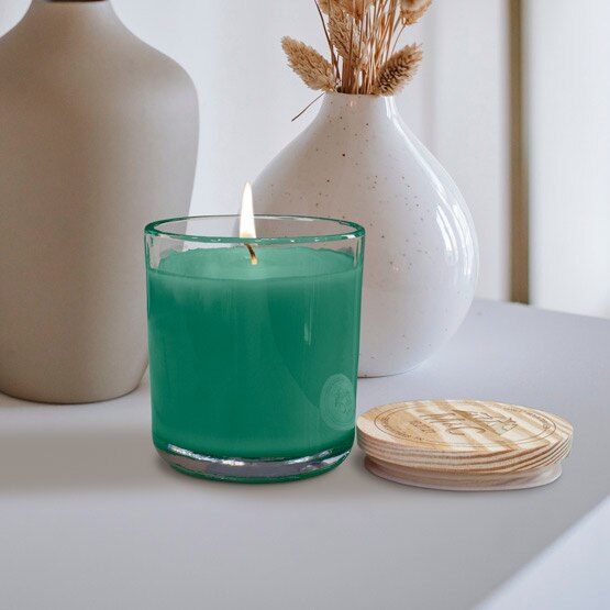 Custom candle with laser engraved lid sitting on an end table. Available in seven different scents
