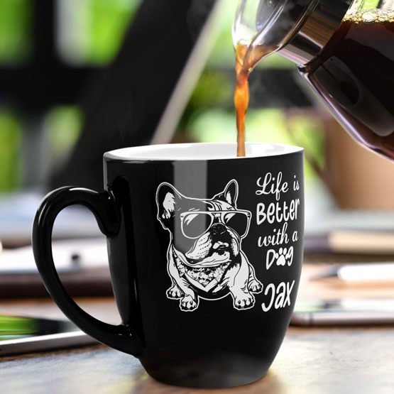 16 oz Custom Black Bistro Coffee Mug Engraved with a Dog named Jax on Table near Laptop.
