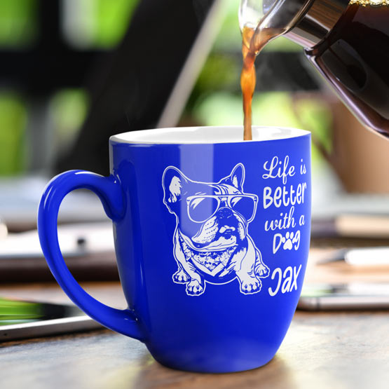 16 oz Custom Blue Bistro Coffee Mug Engraved with a Dog named Jax on Table near Laptop.