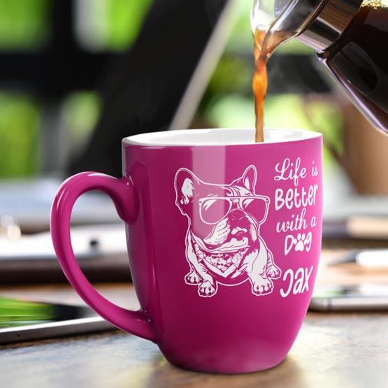 16 oz Custom Pink Bistro Coffee Mug Engraved with a Dog named Jax on Table near Laptop.