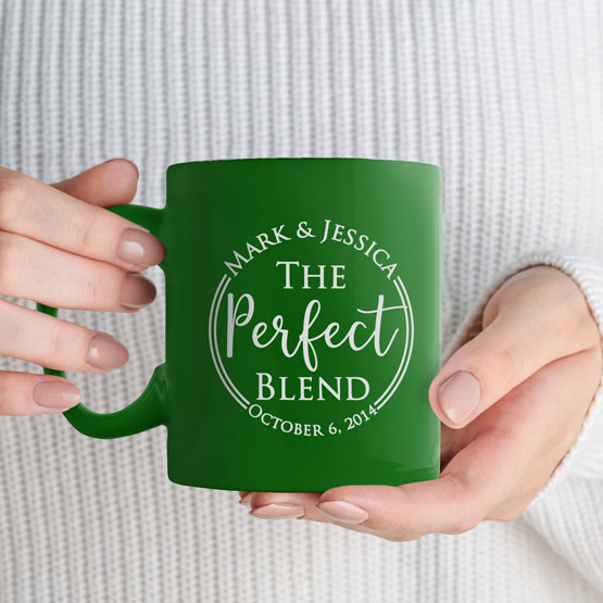 Custom Engraved 11 oz Green Ceramic Mug held by woman with sample engraving for Mark and Jessica