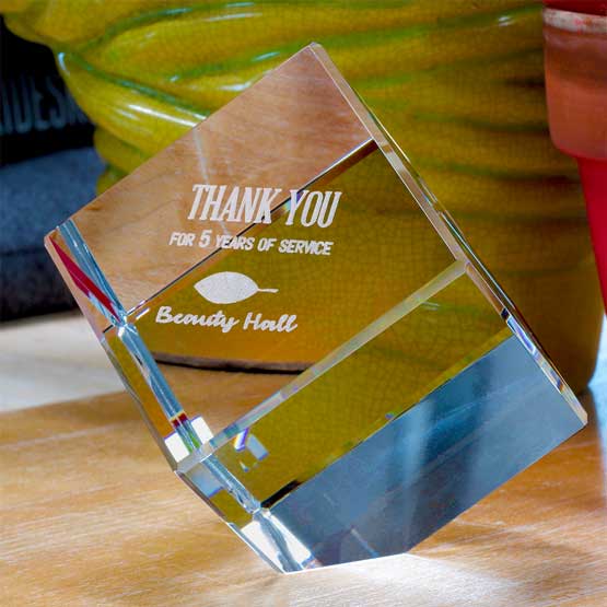 Glass Cube Paperweight on Wood Desk