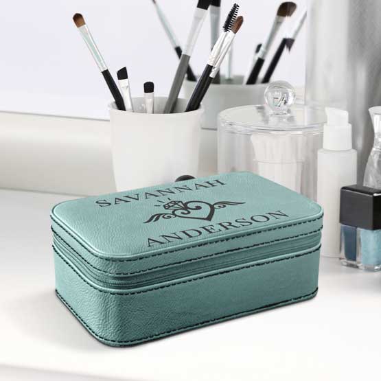 Teal Faux Leather Jewelry Box With Custom Art And Names Text Sitting On White Makeup Dresser With Mirror And Brushes