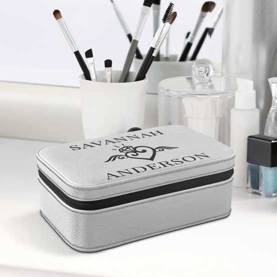White Faux Leather Jewelry Box With Custom Names And Art Sitting On White Makeup Dresser With Brushes And Mirror