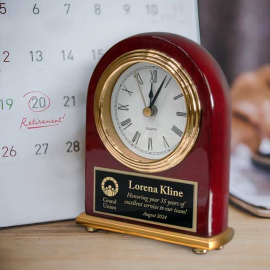 Custom Portrait Rosewood Clock With Engraved Black Aluminum Plate Near Calendar Marking Retirement