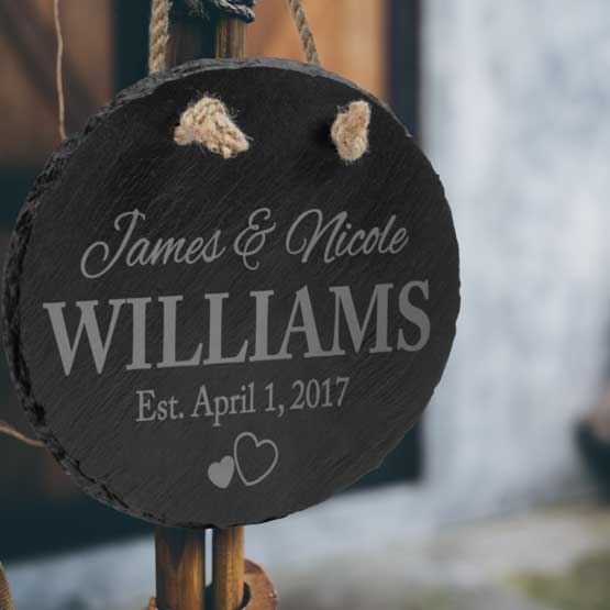 Custom Engraved Hanging Slate Oval Sign for Married Couple James and Nicole hanging from pole.