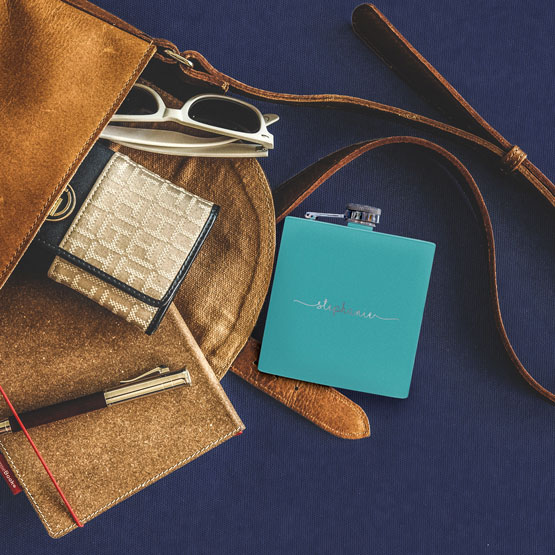 Teal Flask falling out of Purse