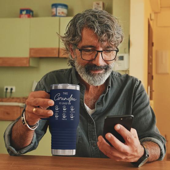 This Grandpa is Loved By Engraved Coffee Tumbler held by elderly man.