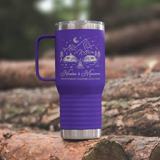 Custom Engraved 20 oz Purple Tumbler on a wooden log with a sample engraving for Nicolas & Mariann