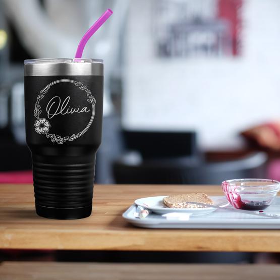 Custom Engraved 30 oz Black Tumbler on a table next to breakfast with a sample engraving for Olivia