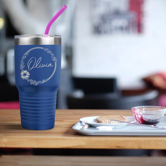 Custom Engraved 30 oz Blue Tumbler on a table next to breakfast with a sample engraving for Olivia