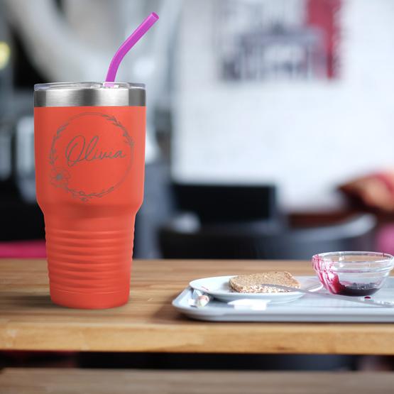 Custom Engraved 30 oz Coral Tumbler on a table next to breakfast with a sample engraving for Olivia