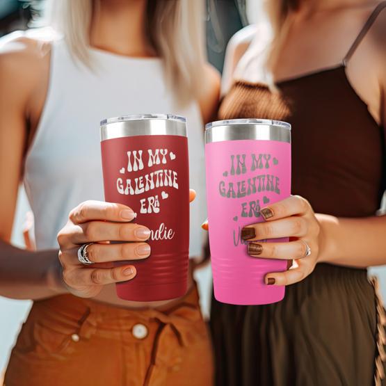 Two friends holding personalized tumbler set, celebrating their friendship for Valentine’s Day.