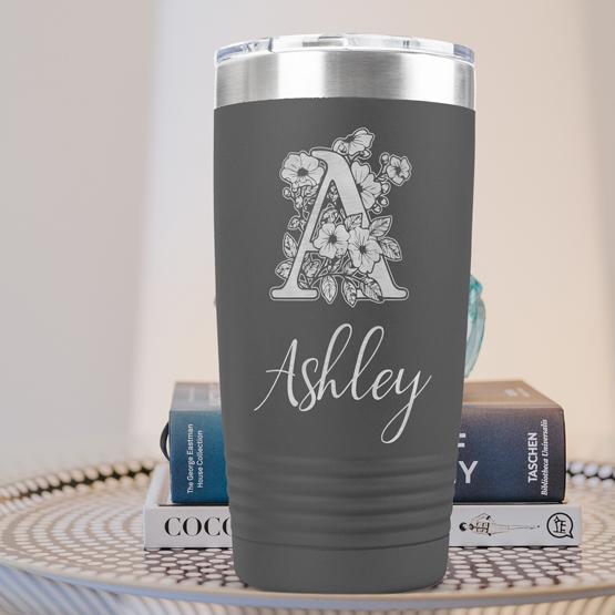 Custom Engraved 20 oz Gray Tumbler on a side table with books