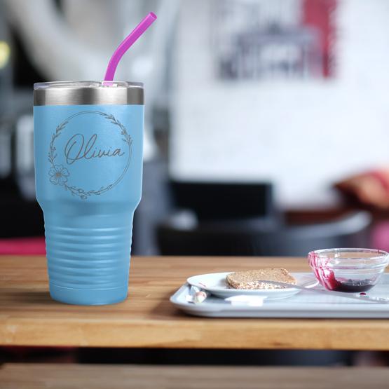 Custom Engraved 30 oz Light Blue Tumbler on a table next to breakfast with a sample engraving for Olivia