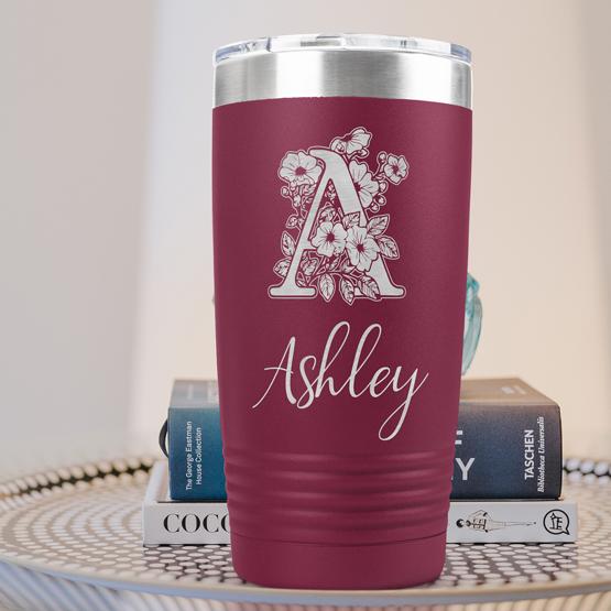 Custom Engraved 20 oz Maroon Tumbler on a side table with books