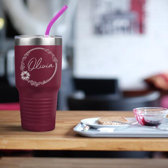 Custom Engraved 30 oz Maroon Tumbler on a table next to breakfast with a sample engraving for Olivia