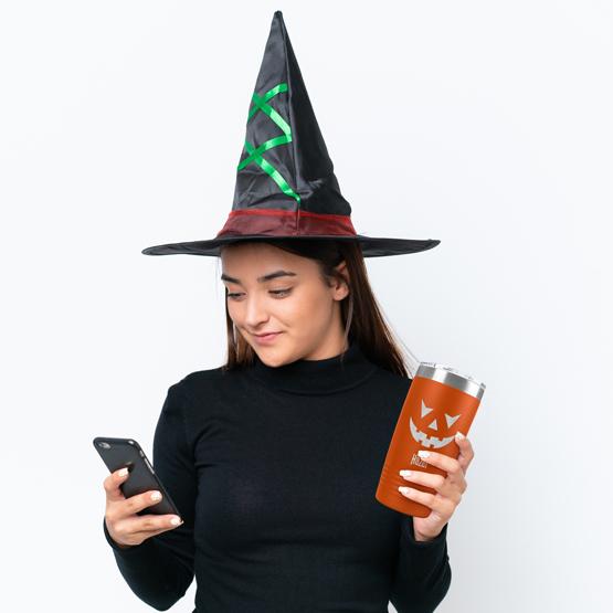 Woman In Witches' Costume Holding Custom Engraved Pumpkin Tumbler For Halloween
