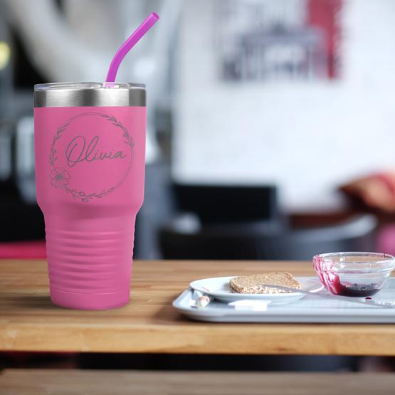 Custom Engraved 30 oz Pink Tumbler on a table next to breakfast with a sample engraving for Olivia