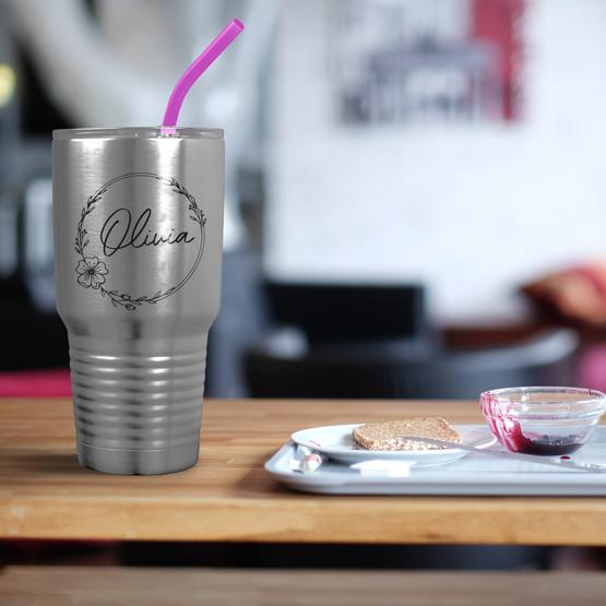 Custom Engraved 30 oz Silver Tumbler on a table next to breakfast with a sample engraving for Olivia