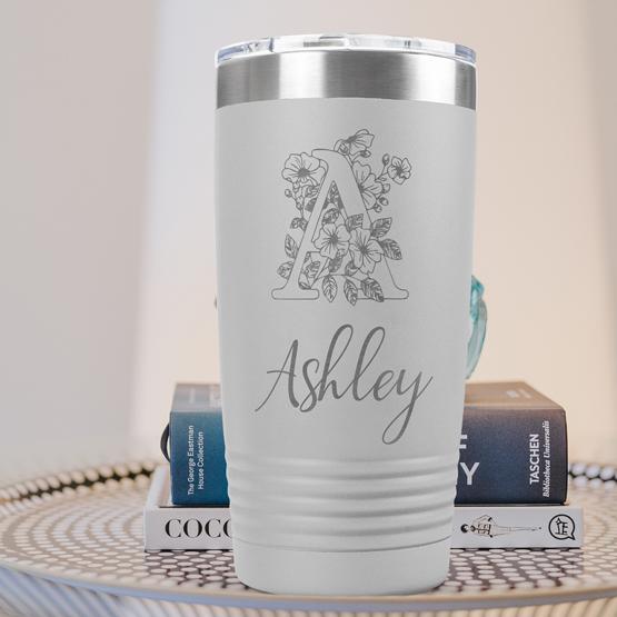 Custom Engraved 20 oz White Tumbler on a side table with books