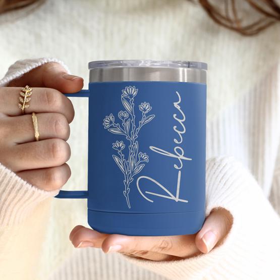 Custom Engraved 15 oz Blue Tumbler Mug being held by a woman with a sample engraving for Rebecca