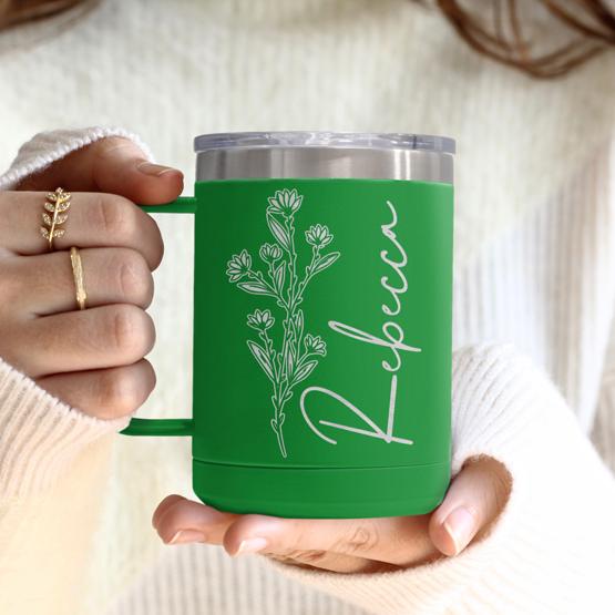 Custom Engraved 15 oz Green Tumbler Mug being held by a woman with a sample engraving for Rebecca