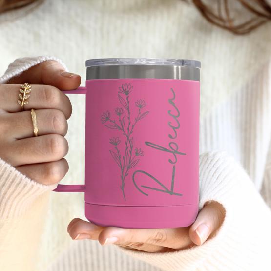 Custom Engraved 15 oz Pink Tumbler Mug being held by a woman with a sample engraving for Rebecca