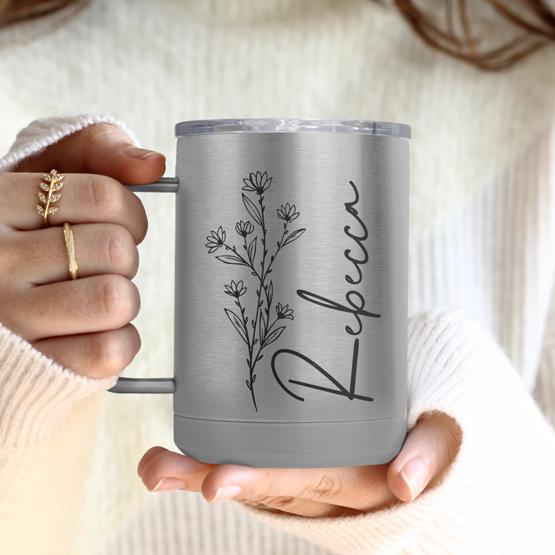 Custom Engraved 15 oz Silver Tumbler Mug being held by a woman with a sample engraving for Rebecca