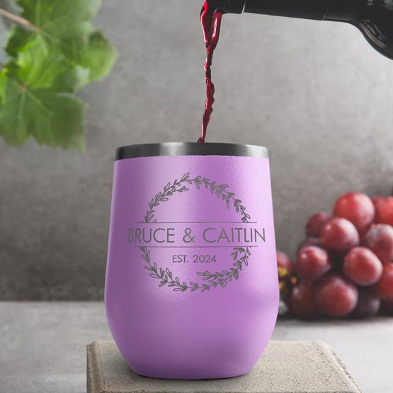 Custom Engraved 12 oz Light Purple Wine Tumbler pouring wine with a sample engraving for Bruce & Caitlin