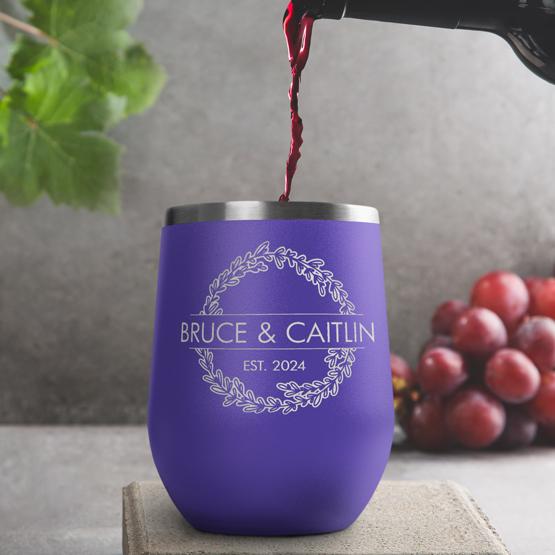 Custom Engraved 12 oz Purple Wine Tumbler pouring wine with a sample engraving for Bruce & Caitlin