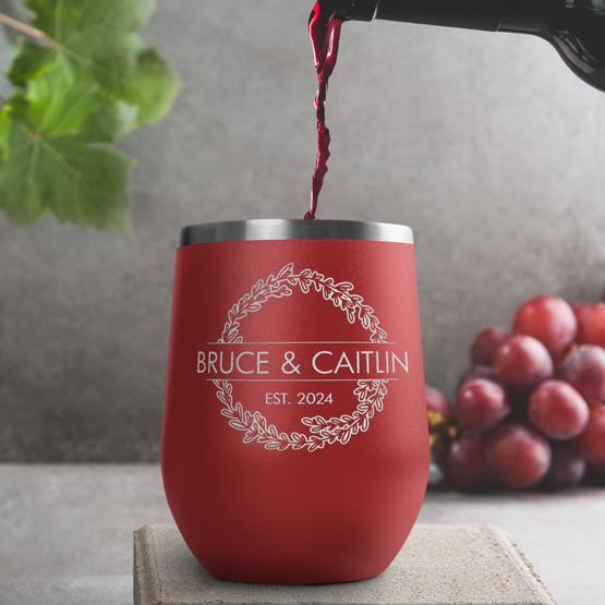 Custom Engraved 12 oz Red Wine Tumbler pouring wine with a sample engraving for Bruce & Caitlin