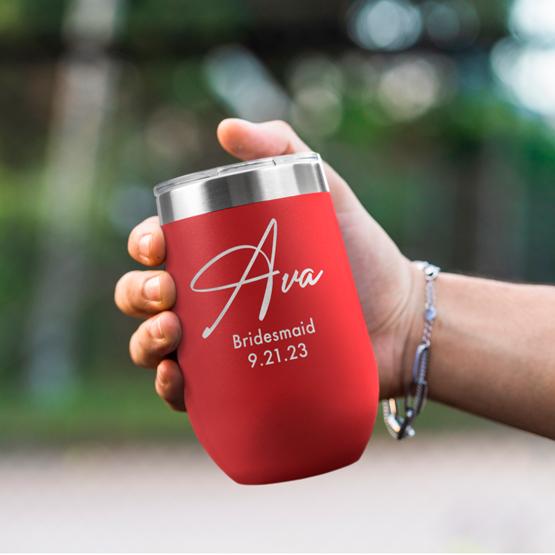 Custom Engraved 16 oz Red Wine Tumbler held by woman with the engraving for Ava.