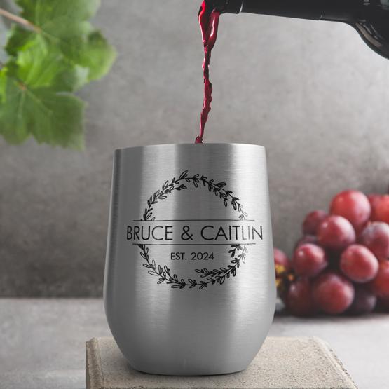 Custom Engraved 12 oz Silver Wine Tumbler pouring wine with a sample engraving for Bruce & Caitlin