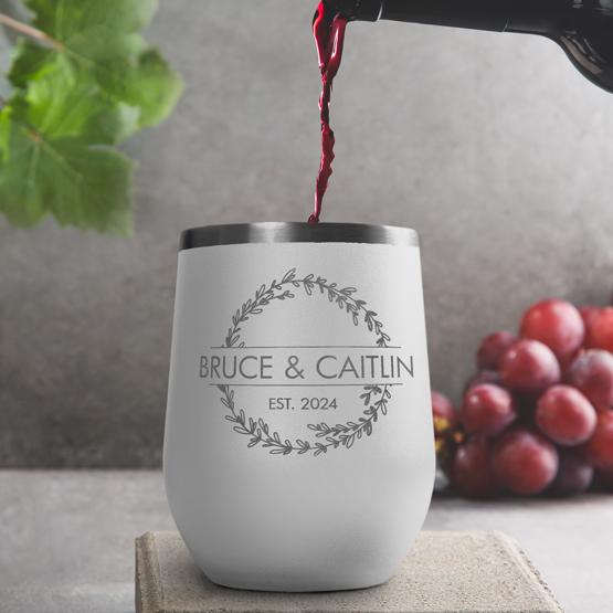 Custom Engraved 12 oz White Wine Tumbler pouring wine with a sample engraving for Bruce & Caitlin