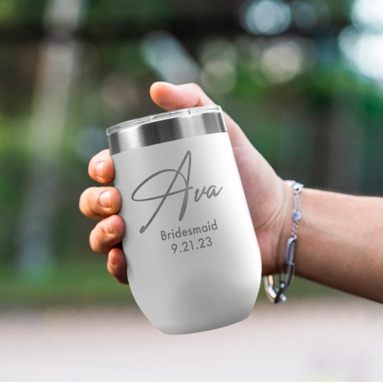 Custom Engraved 16 oz White Wine Tumbler held by woman with the engraving for Ava.