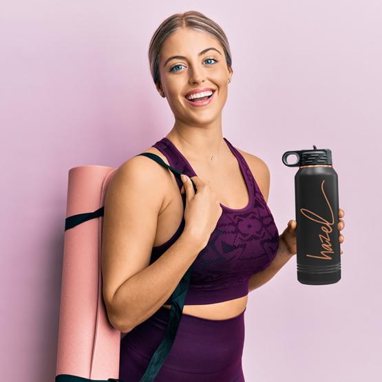 Woman Going To Work Out With A 32 Oz Black With Gold Water Bottle