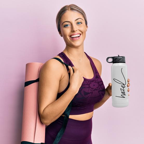 Woman Going To Work Out With A 32 Oz White With Gold Water Bottle
