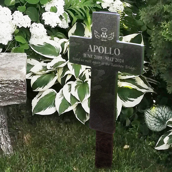 Custom Engraved Granite Cross on Garden Stake for the dog Apollo near stone bench and flowers