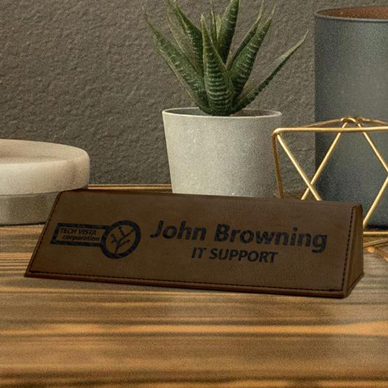 Custom Laser Engraved Brown Faux Leather Desk Wedge Name Plate on Desk near Plant and Light