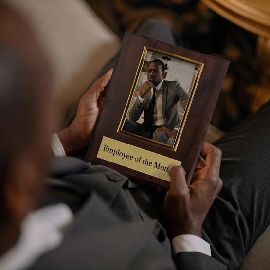 Man Holding Picture Frame Plaque